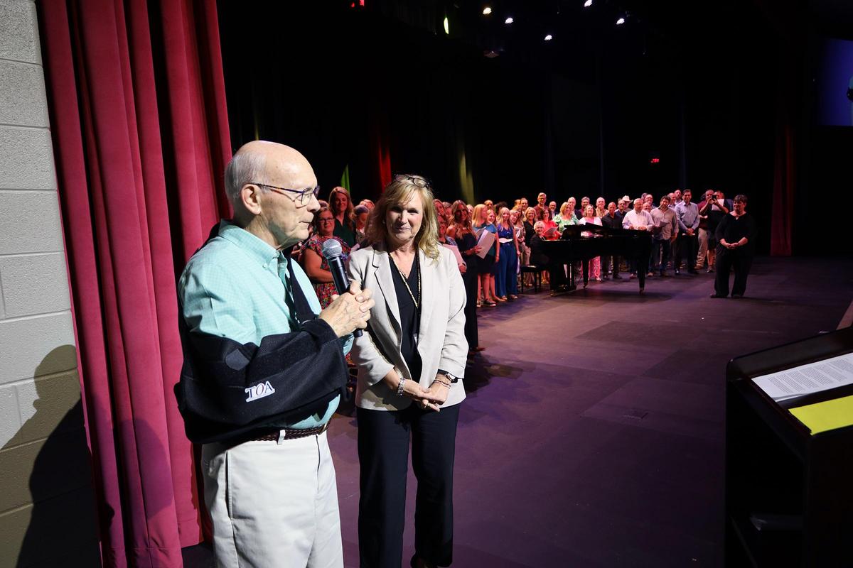 John Bryan speaking on the Riverdale auditorium stage during its 2026 dedication
